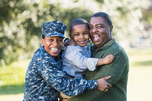 Family picture with male, child, and female in Navy uniform